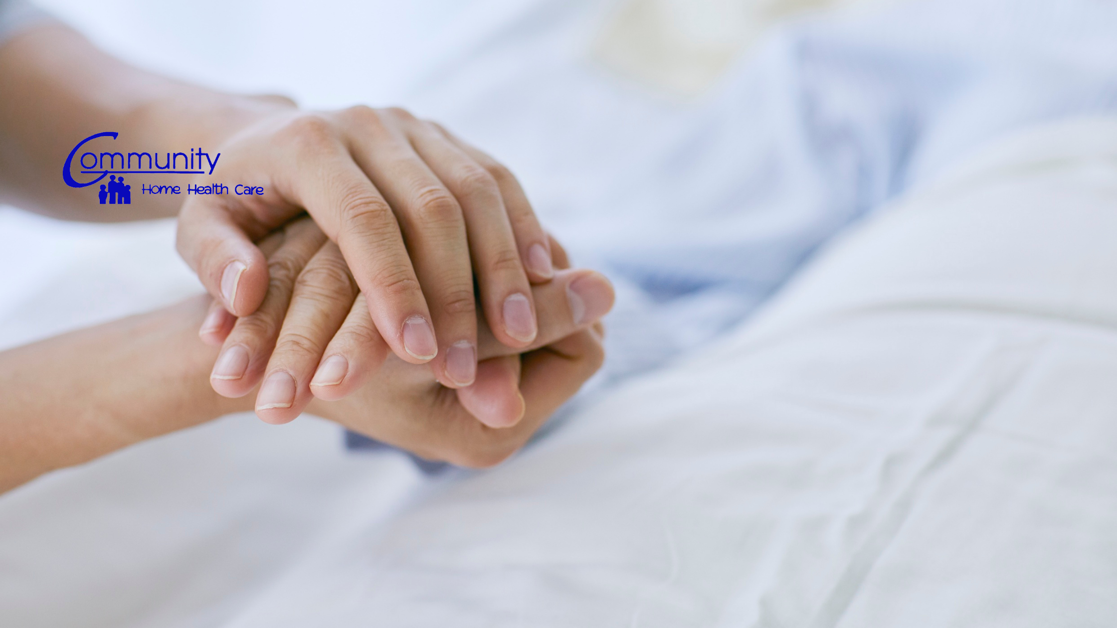 Caregiver holding a patient’s hand while providing post-hospital home health care in Fort Wayne, Indiana